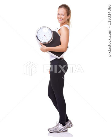 Workout, scale and portrait of woman with confidence, fitness and wellness with healthy body in studio. Health, exercise commitment and happy girl with weight loss measurement on white background. Workout, scale and portrait of woman with confidence, fitness and wellness with healthy body in studio. Health, exercise commitment and happy girl with weight loss measurement on white background. 139334366