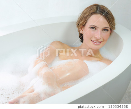 Woman, portrait and bubble bath for routine, relaxing and cleaning hygiene with beauty. Skincare, wellness and dermatology for bathing, female person and bathroom for grooming and cosmetic care Woman, portrait and bubble bath for routine, relaxing and cleaning hygiene with beauty. Skincare, wellness and dermatology for bathing, female person and bathroom for grooming and cosmetic care 139334368