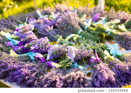 Table full of ready bouquets and sachets made of lavender. Harvest of lavender in garden 139334449