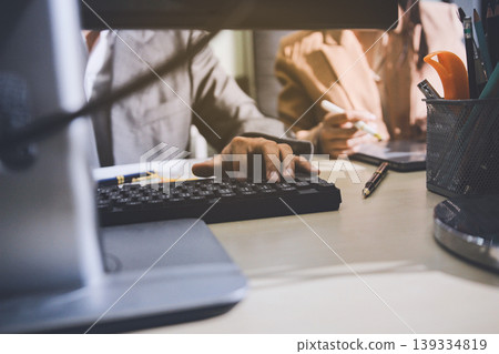 Accounting company provide finance and taxation planning for profitable cash flow, Auditor accountant working in office, analyze financial data and accounting record with calculator Accounting company provide finance and taxation planning for profitable cash flow, Auditor accountant working in office, analyze financial data and accounting record with calculator 139334819
