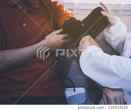 Doctor checks patient's blood pressure with cuff and stethoscope in a medical Doctor checks patient's blood pressure with cuff and stethoscope in a medical 139334830