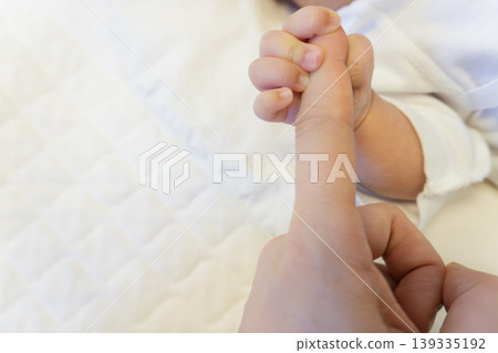 A hand of a newly born baby A hand of a newly born baby 139335192