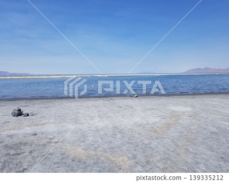 Expansive view of the Great Salt Lake shoreline under a bright blue sky. 139335212