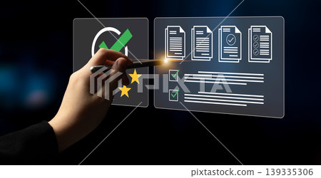 Hand Using Stylus to Interact with Digital Checklist and Documents on Futuristic Interface in a Dark Background Ledger Hand Using Stylus to Interact with Digital Checklist and Documents on Futuristic Interface in a Dark Background Ledger 139335306