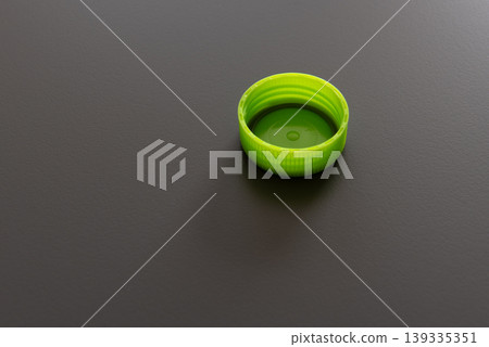 green plastic bottle cap on gray background green plastic bottle cap on gray background 139335351