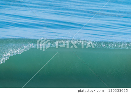 The crest of the waves crashing down 139335635