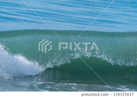 The crest of the waves crashing down 139335637