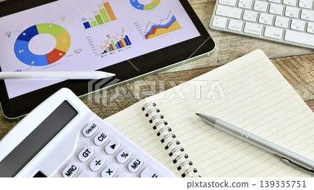 Image of a desk job involving data analysis and business strategy. Image of a desk job involving data analysis and business strategy. 139335751