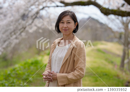 Senior woman walking in a park in spring Senior woman walking in a park in spring 139335932