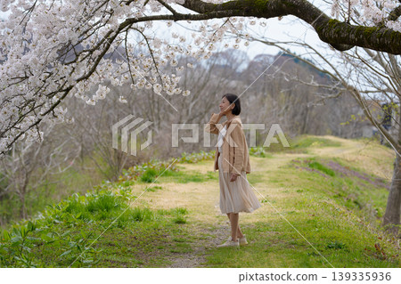 Senior woman walking in a park in spring Senior woman walking in a park in spring 139335936