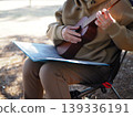 Practicing the ukulele outdoors 139336191