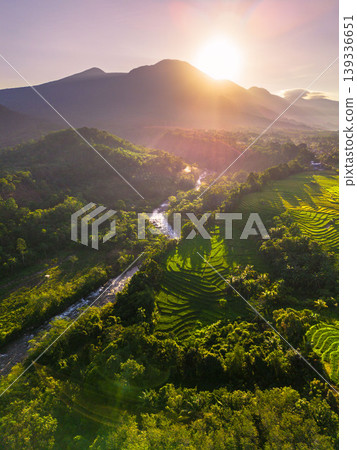 Beautiful morning view in Indonesia, panoramic landscape of rice fields with mountain ranges and clear sky Beautiful morning view in Indonesia, panoramic landscape of rice fields with mountain ranges and clear sky 139336651