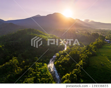 Beautiful morning view in Indonesia, panoramic landscape of rice fields with mountain ranges and clear sky Beautiful morning view in Indonesia, panoramic landscape of rice fields with mountain ranges and clear sky 139336655