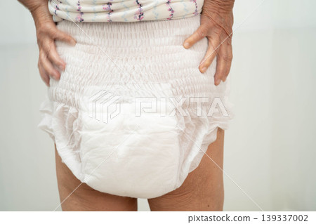 Asian senior woman patient wearing adult incontinence diaper pad in hospital. Asian senior woman patient wearing adult incontinence diaper pad in hospital. 139337002