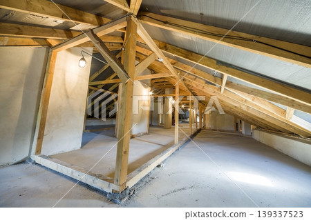 Attic of a building with wooden beams of a roof structure. Attic of a building with wooden beams of a roof structure. 139337523