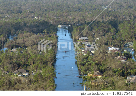 Aftermath of natural disaster. Surrounded by hurricane rainfall flood waters homes in Florida residential area Aftermath of natural disaster. Surrounded by hurricane rainfall flood waters homes in Florida residential area 139337541