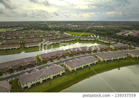 Aerial view of tightly packed homes in Florida closed living clubs. Family houses as example of real estate development in American suburbs Aerial view of tightly packed homes in Florida closed living clubs. Family houses as example of real estate development in American suburbs 139337559