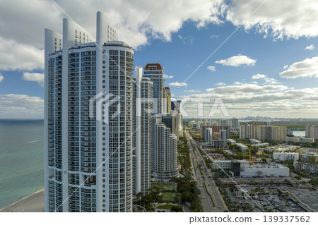 Aerial view of Sunny Isles Beach city with luxurious highrise hotels and condos on Atlantic ocean shore. American tourism infrastructure in southern Florida 139337562