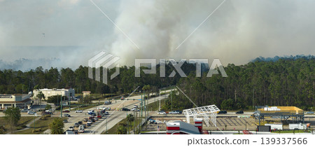Aerial view of strong wildfire burning severely in North Port city, Florida. Natural disaster during dry season in jungle woods Aerial view of strong wildfire burning severely in North Port city, Florida. Natural disaster during dry season in jungle woods 139337566