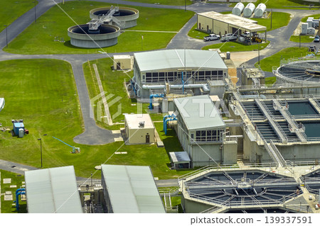 Aerial view of modern water cleaning facility at urban wastewater treatment plant. Purification process of removing undesirable chemicals, suspended solids and gases from contaminated liquid Aerial view of modern water cleaning facility at urban wastewater treatment plant. Purification process of removing undesirable chemicals, suspended solids and gases from contaminated liquid 139337591