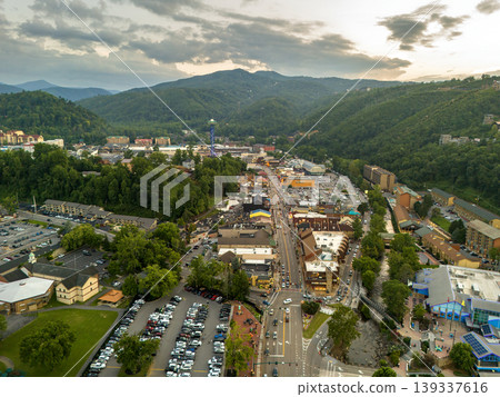 Aerial view of Gatlinburg, Tennessee with downtown hotels, restaurants and tourist shops along the Parkway street surrounded by Appalachian Mountains. Aerial view of Gatlinburg, Tennessee with downtown hotels, restaurants and tourist shops along the Parkway street surrounded by Appalachian Mountains. 139337616