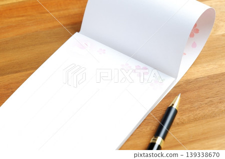 Writing a letter - an image of writing a letter on a notepad. 139338670