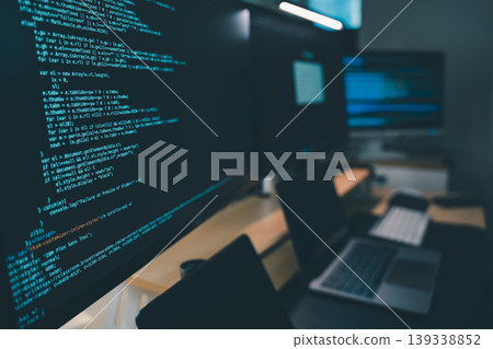 Close up of computer monitors displaying source code in a modern workstation with laptop and digital devices, showing software development workflow, programming process, and technical productivity in Close up of computer monitors displaying source code in a modern workstation with laptop and digital devices, showing software development workflow, programming process, and technical productivity in 139338852