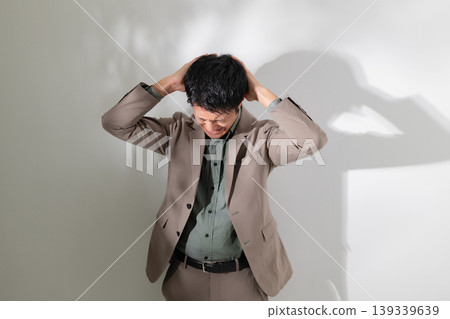 An agonizing businessman An agonizing businessman 139339639