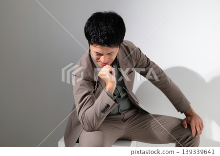 An agonizing businessman An agonizing businessman 139339641