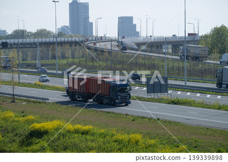 Busy Urban Highway With Trucks and City Skyline Busy Urban Highway With Trucks and City Skyline 139339898