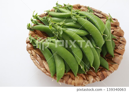 Harvested snap peas against a white background. Harvested snap peas against a white background. 139340063