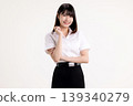 Portrait of a confident young Asian woman in white shirt student uniform smiling and looking at camera. Happy female university student with arms crossed posing isolated on white background. 139340279