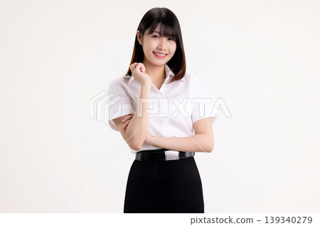 Portrait of a confident young Asian woman in white shirt student uniform smiling and looking at camera. Happy female university student with arms crossed posing isolated on white background. Portrait of a confident young Asian woman in white shirt student uniform smiling and looking at camera. Happy female university student with arms crossed posing isolated on white background. 139340279