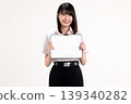 Smiling young Asian woman in student uniform holding digital tablet with blank white screen for mockup. Happy female university student showing tablet computer isolated on white background. 139340282