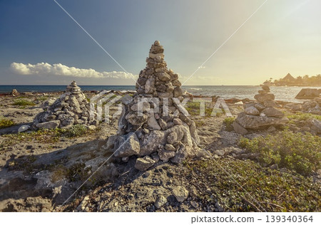 Cairns marking the shore in puerto aventuras, riviera maya, at sunset Cairns marking the shore in puerto aventuras, riviera maya, at sunset 139340364