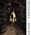 Father and son walking through tunnel in tulum, mexico, towards light 139340388