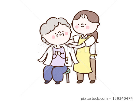 A caregiver gently places a cardigan over an elderly person who is sitting down. A caregiver gently places a cardigan over an elderly person who is sitting down. 139340474