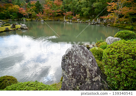 The garden scene of Tenryuji Temple at autumn. Famous temple in Japan. Tenryuji Temple is a Japanese traditional temples in Kyoto. Autumn and garden view. Nature and Travel concept. The garden scene of Tenryuji Temple at autumn. Famous temple in Japan. Tenryuji Temple is a Japanese traditional temples in Kyoto. Autumn and garden view. Nature and Travel concept. 139340541