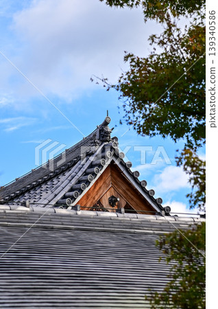 Close-up of the roof of Tenryuji Temple in Kyoto, Japan with trees. Roof tile pattern. Major tourist attraction in Kansai region in Japan. Japan famous historic architecture. Building structure. 139340586