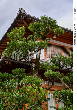 Close-up of the roof of Tenryuji Temple in Kyoto, Japan with trees. Roof tile pattern. Major tourist attraction in Kansai region in Japan. Japan famous historic architecture. Building structure. Close-up of the roof of Tenryuji Temple in Kyoto, Japan with trees. Roof tile pattern. Major tourist attraction in Kansai region in Japan. Japan famous historic architecture. Building structure. 139340598