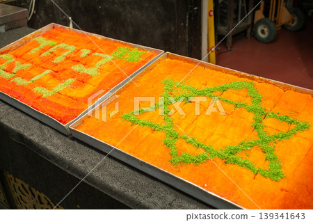 [Jerusalem] A sweet treat sold at a confectionery shop in the Mahane Yehuda Market, featuring a Star of David drawn on the surface of the dough. 139341643