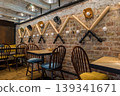 Rustic Bar Interior With Baseball Decor Brick Wall and Wooden Tables in Dim Light 139341671