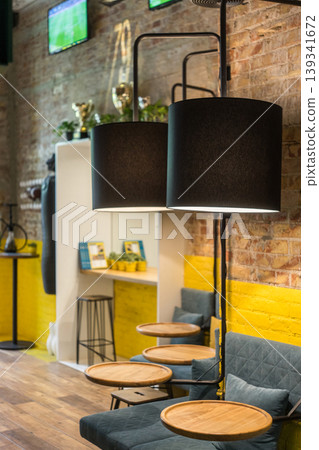 Modern Industrial Bar Interior With Yellow Accents Seating and Lounge Atmosphere Modern Industrial Bar Interior With Yellow Accents Seating and Lounge Atmosphere 139341672