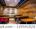Cozy Restaurant Interior With Wooden Design Elements and Cultural Decorative Accents 139341828