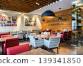 Modern Restaurant Interior With Artistic Decor Seating and Warm Ambient Lighting Design 139341850