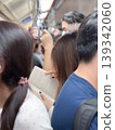 Candid picture of woman reading the book inside the subway train among the crowded passengers during rush hours in the city 139342060