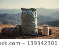 Worn Backpack and Camping Gear on Mountain Ridge With Rolled Sleeping Mat and Canisters 139342301