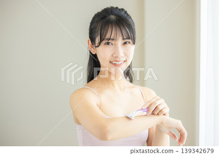 Young woman getting body care Young woman getting body care 139342679