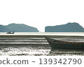 Abandoned wooden fsihing boat on the beach with seascape and space between two islands in background 139342790