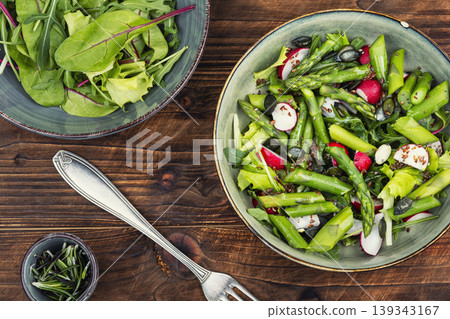 Fresh vegetable salad with asparagus radish on a wooden rustic background. Fresh vegetable salad with asparagus radish on a wooden rustic background. 139343167
